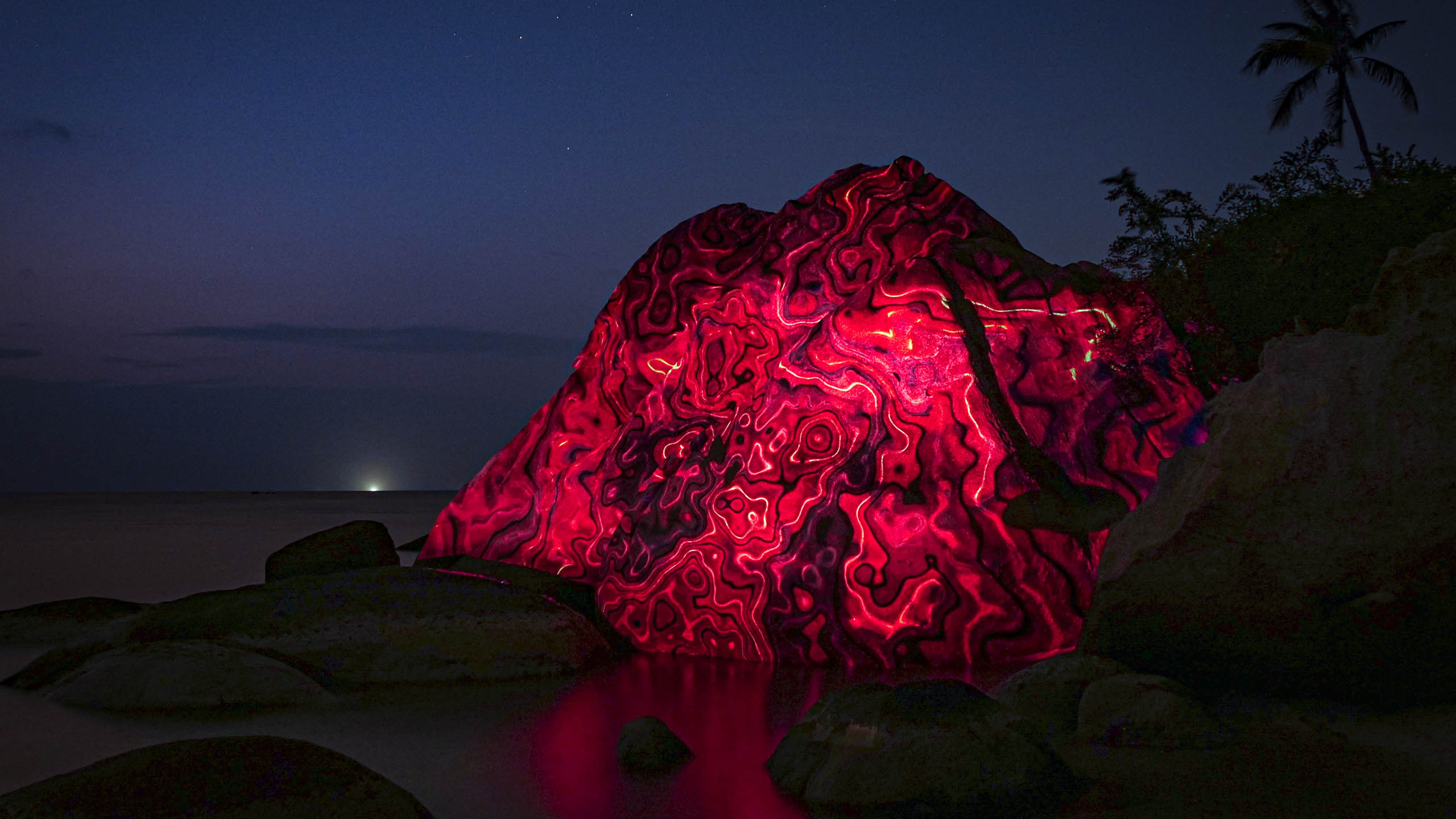 nature art, 3d projection mapping with lava fire by philipp frank. Located on a rock at the beach