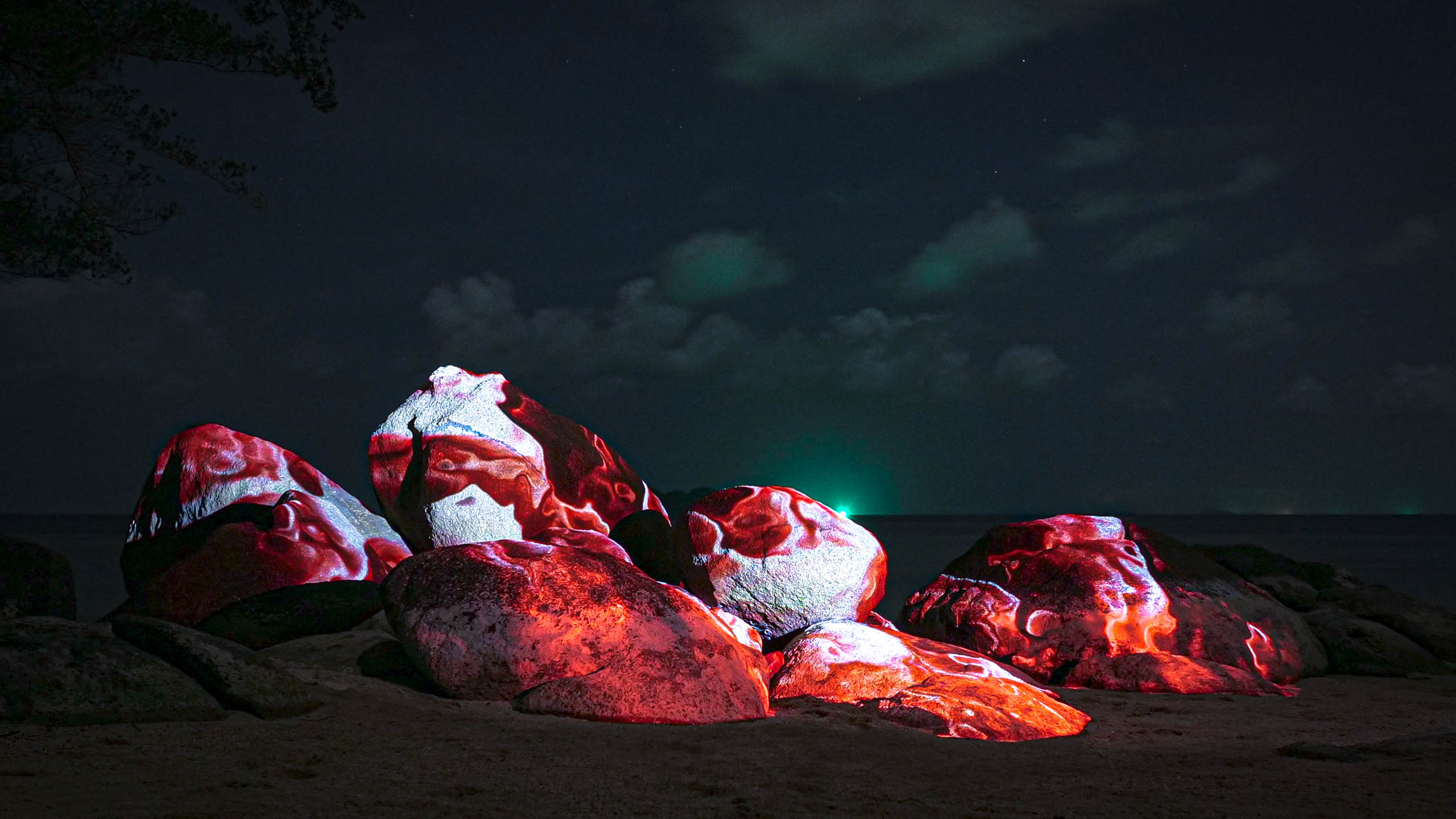 light art, 3d projection mapping with red colors, by philipp frank. Located on a rock at the beach