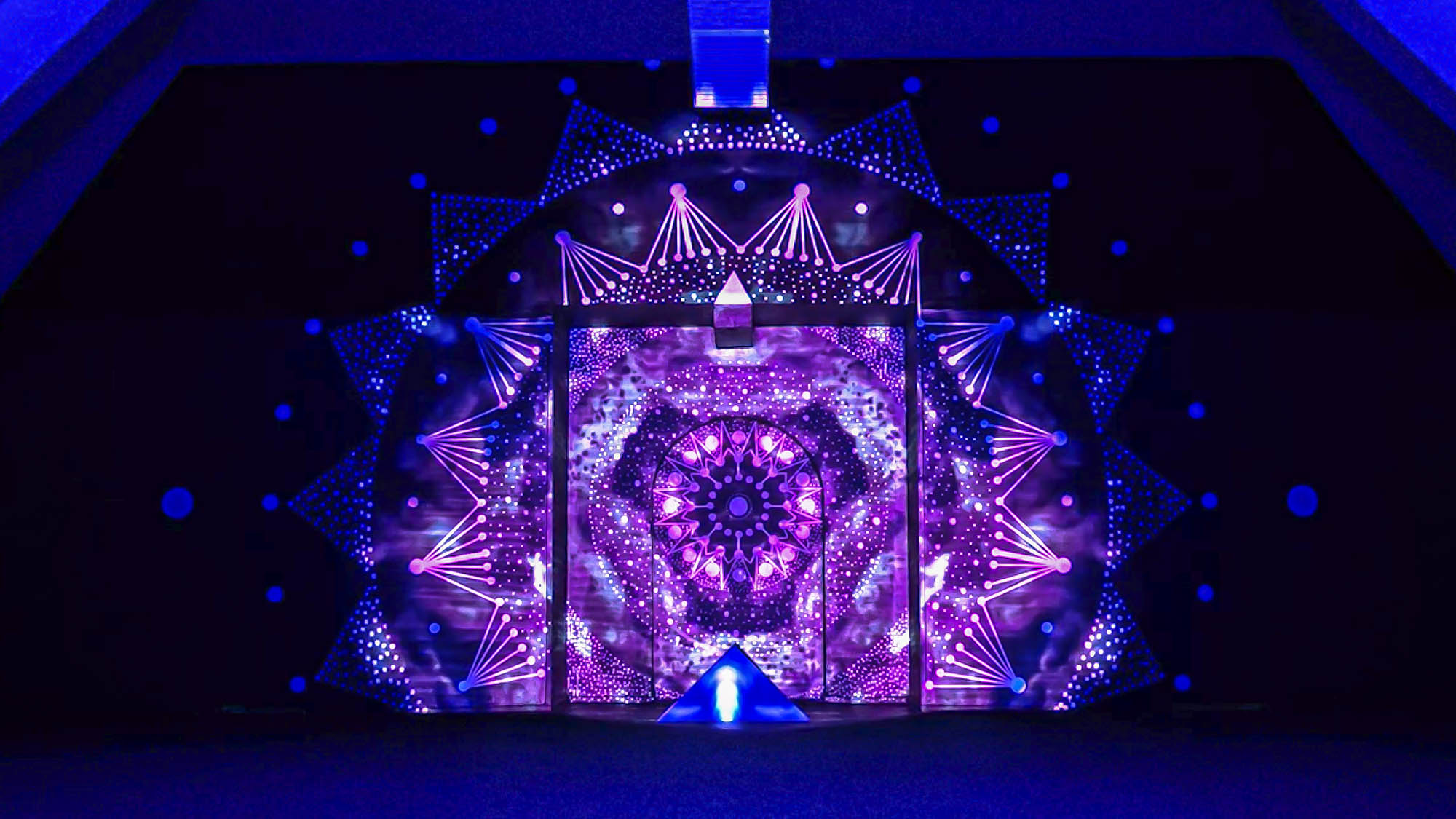 Image of a video art installation combined with a mural painting. Mandala geometric design with projection mapping art. Light artist philipp frank