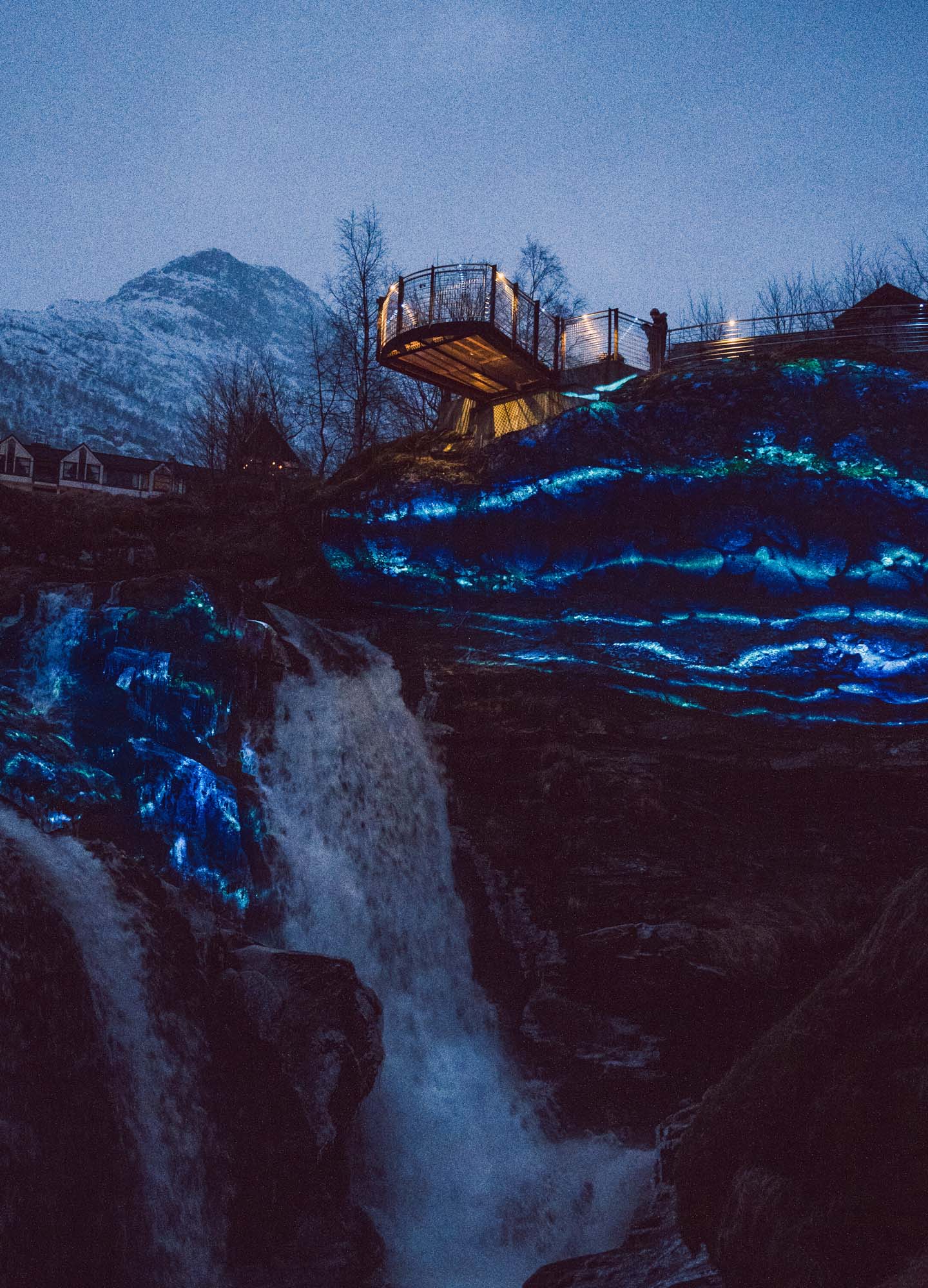 A video mapping show with blue color projected onto rocks