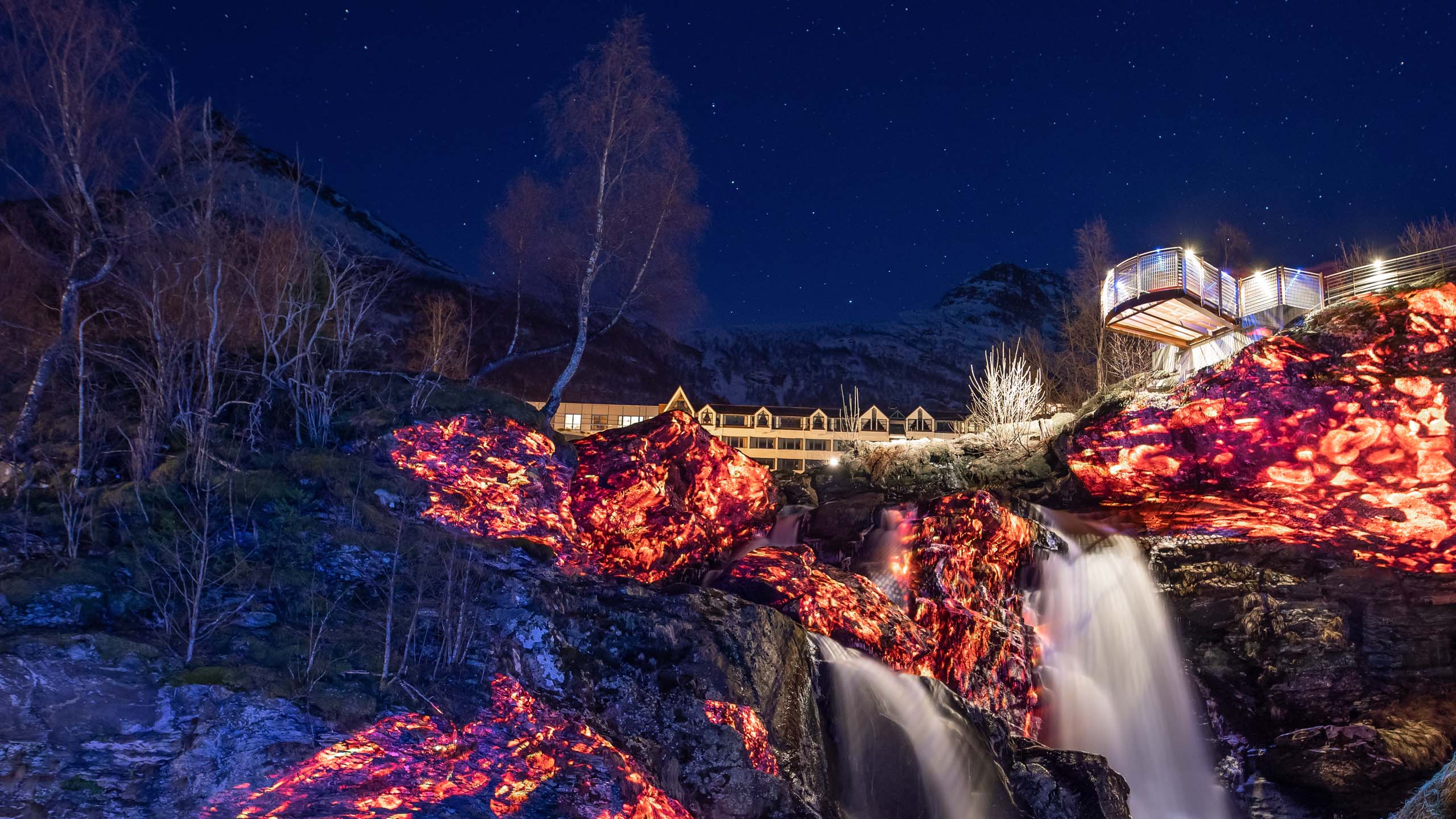 Video-mapping in nature on rocks and a waterfall with fire and lava visuals Geiranger Fjord