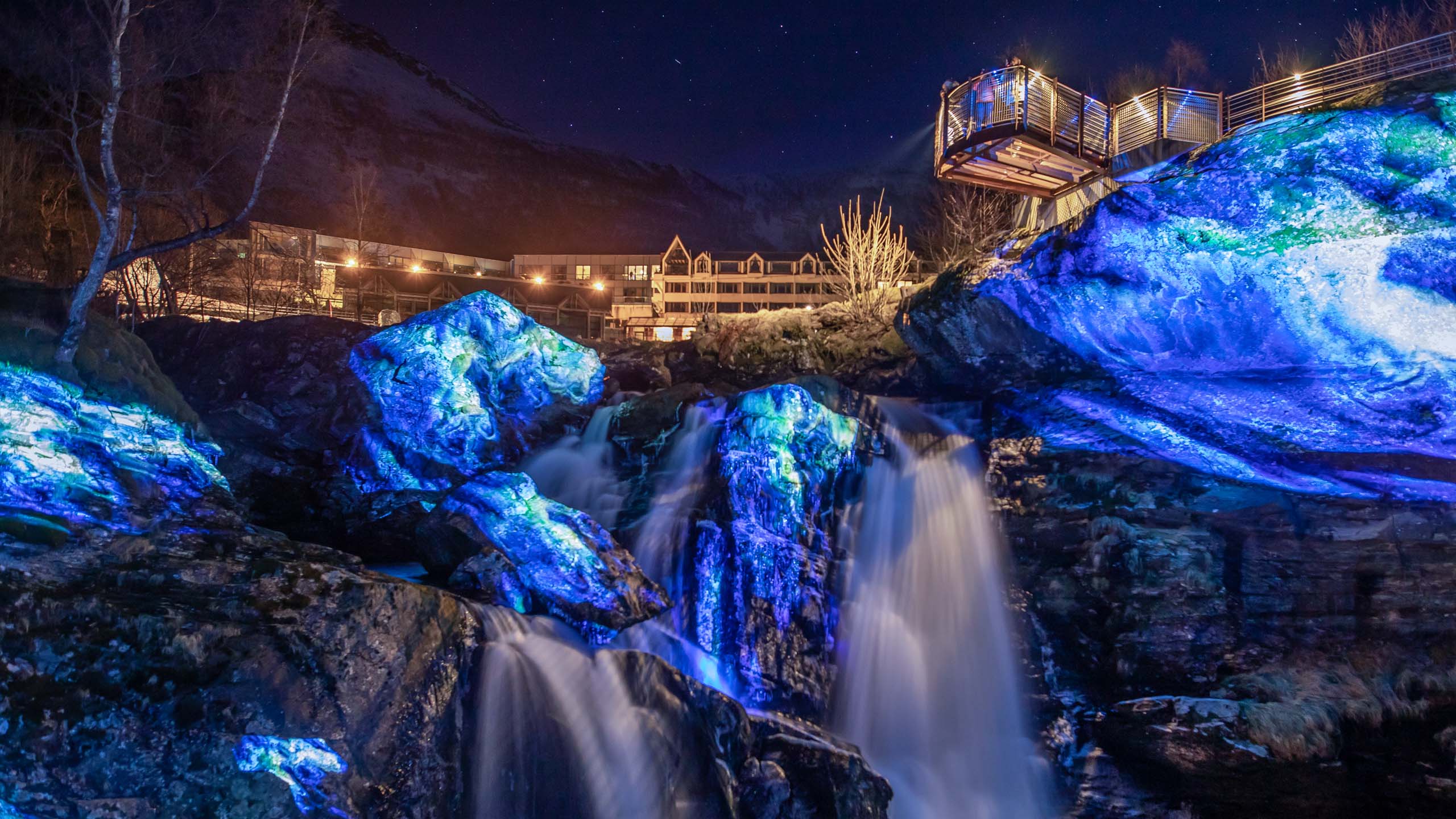 Video-mapping in nature on rocks and waterfall with beautiful blue color visuals