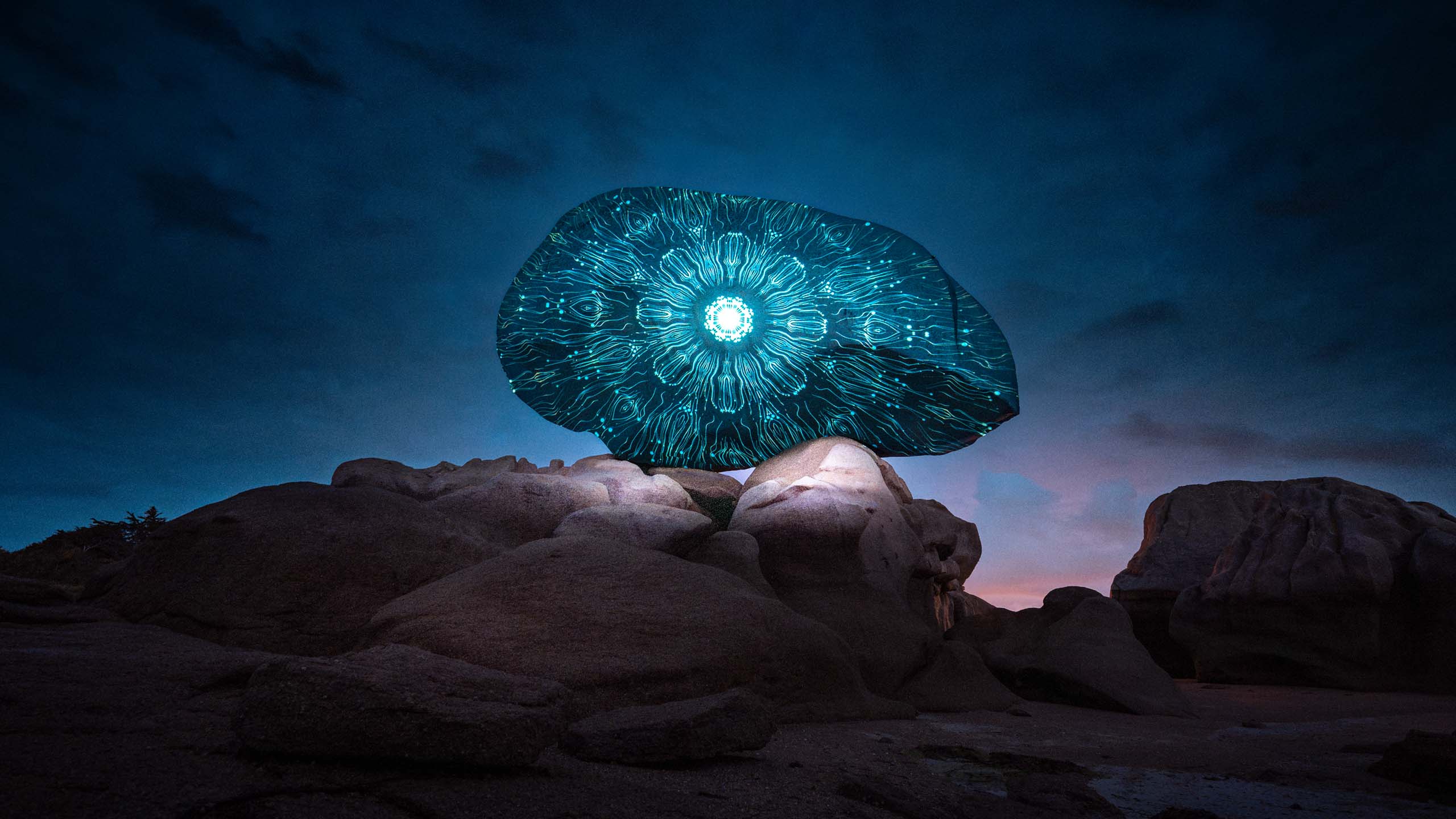 Land-art projection mapping light art on a rock at Côte de Granit Rose in France