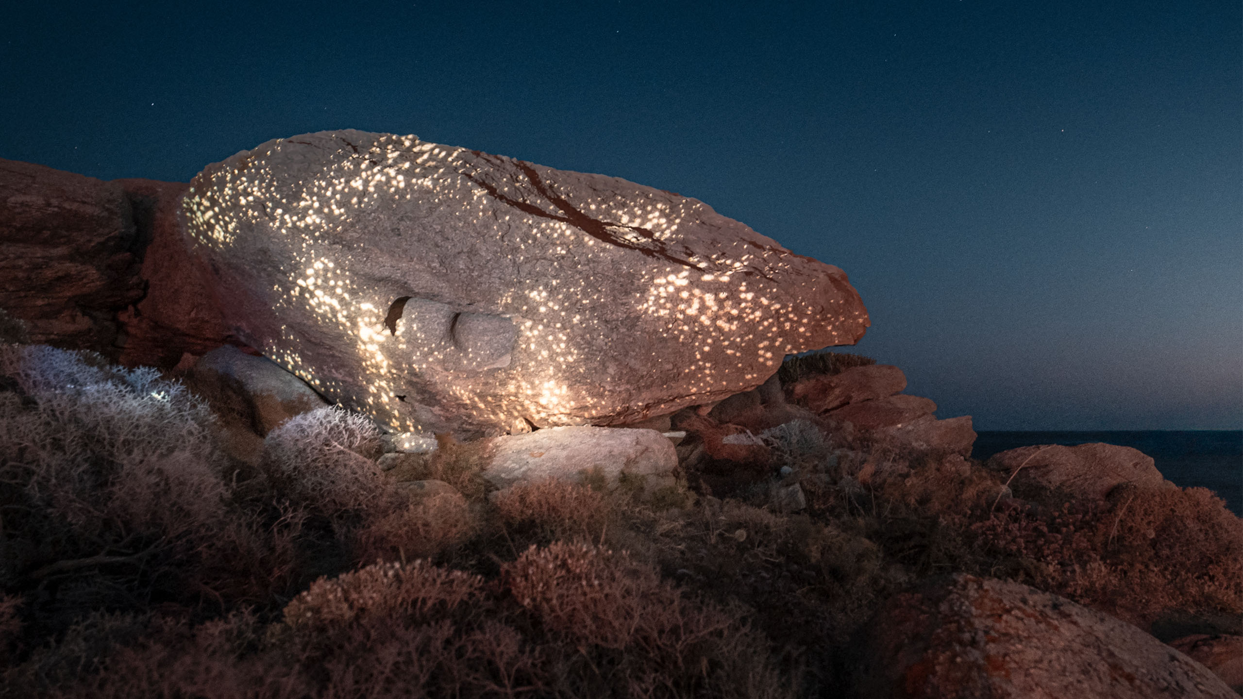 Mykonos Lightcodes_06 Golden light patterns projected onto coastal rock at sunset, Mykonos Lightcodes by Philipp Frank.
